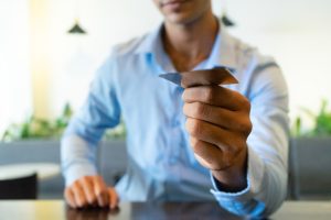 Close Up Indian Businessman Hand Giving Business Card Scaled
