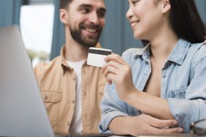 Happy Couple Shopping Online Using Laptop Credit Card Scaled