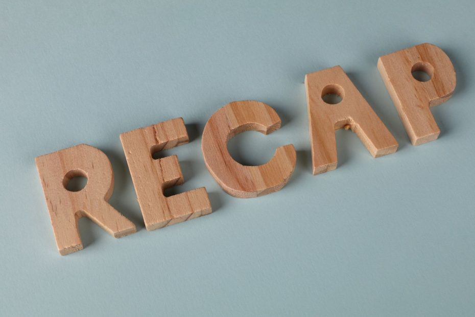 Wooden letters forming the word 'RECAP' on a soft blue background, ideal for presentations.